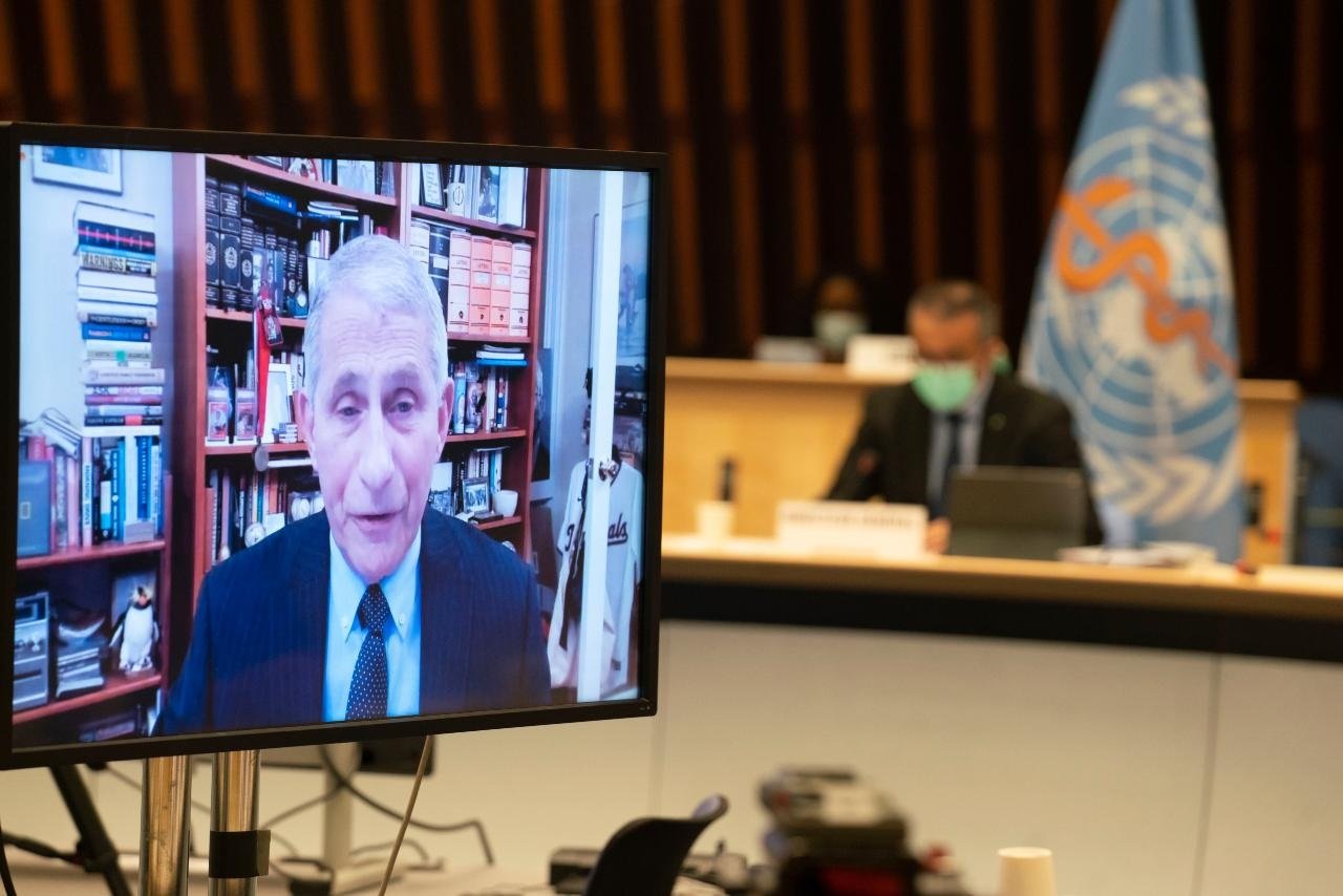 Dr Anthony S. Fauci on screen with Dr Tedros in the background.